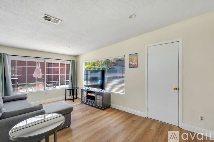A living room with a grey sofa and a television.