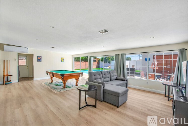 A room with a pool table and a couch.