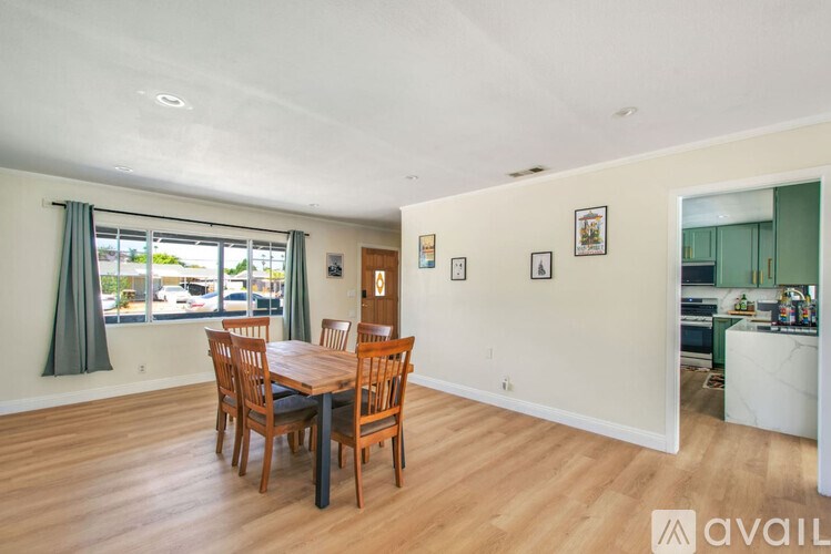 A dining room with a table and chairs.