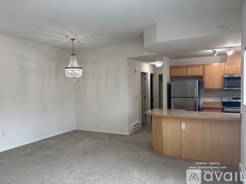 A kitchen area with a refrigerator, microwave, and oven.