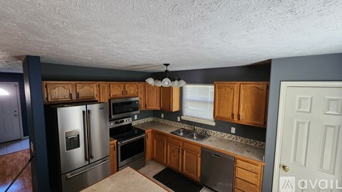 A kitchen with wooden cabinets and stainless steel appliances.