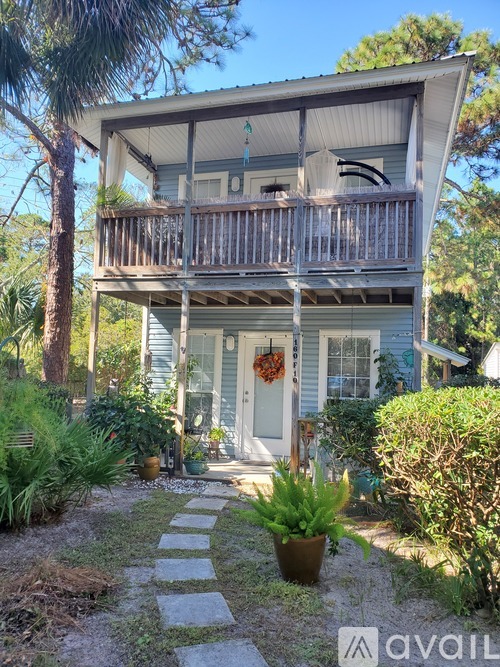 A house with a balcony and a door with a wreath on it.
