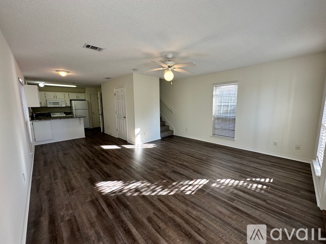 A room with a ceiling fan and wooden flooring is available for rent.