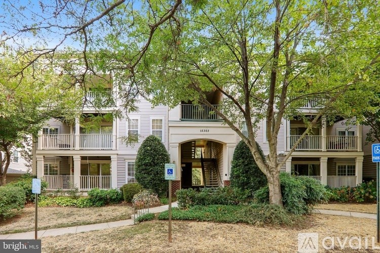 A tree in front of a building with a sign that says "bright".