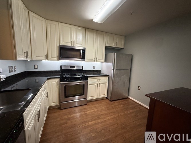 A kitchen with white cabinets and stainless steel appliances.