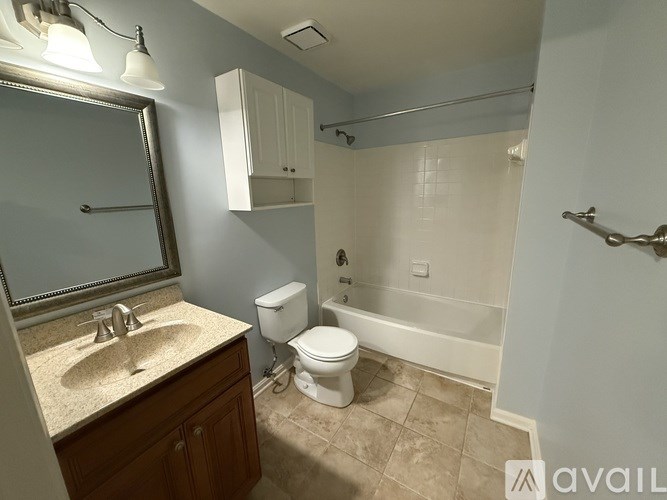 A bathroom with a sink, toilet, and bathtub.