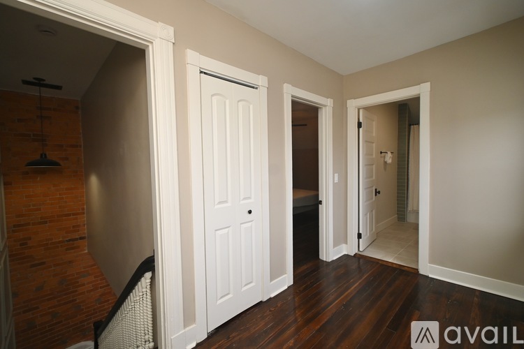 A bedroom with a large bed and a white bedspread.
