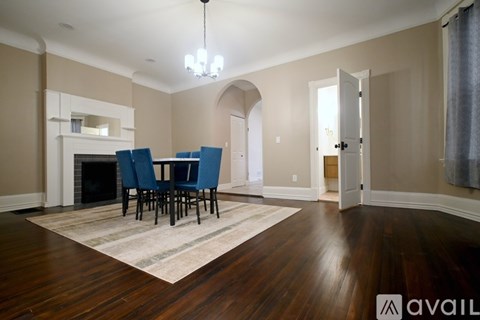A living room with a fireplace and a dining table set up.