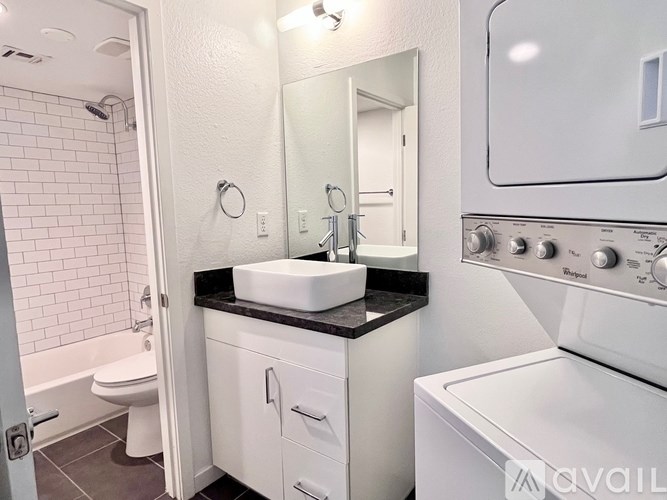 A bathroom with a white oven and sink.