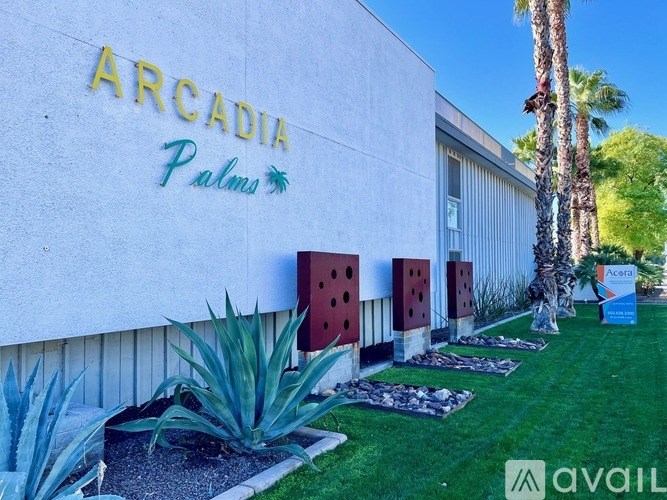 A white building with a sign that says Arcadia Palms.