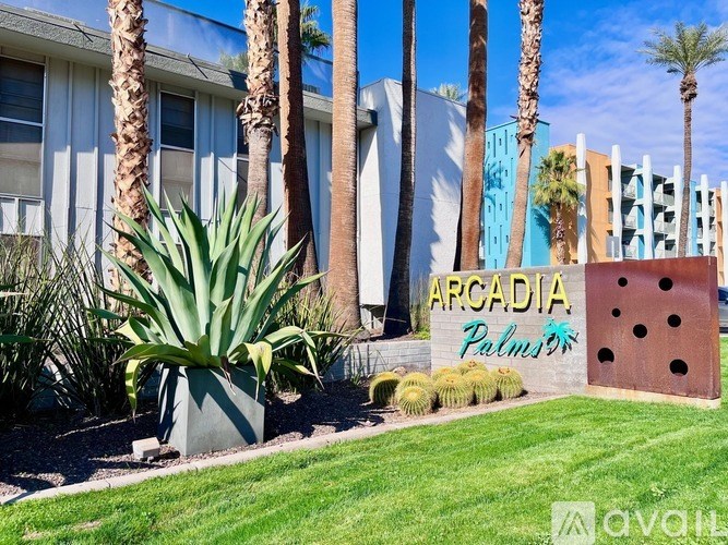 A sign that says Arcadia Palms in front of a building.
