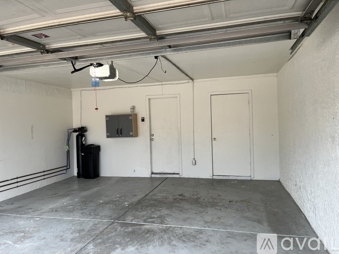A large empty garage with a white ceiling and concrete floor.