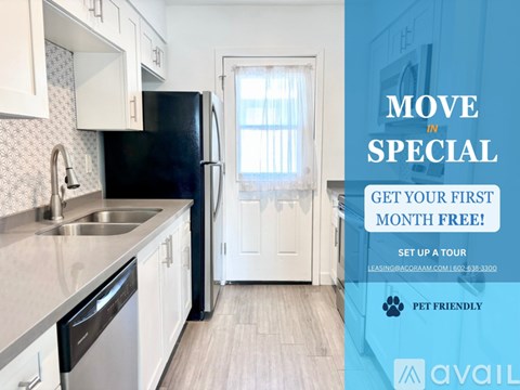A kitchen with a black fridge and white cabinets is advertised for rent.