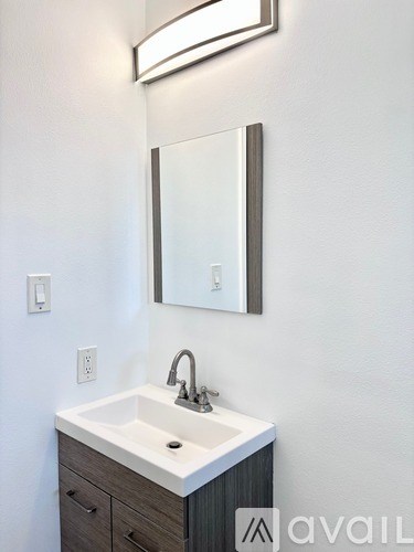 A bathroom sink with a mirror above it.