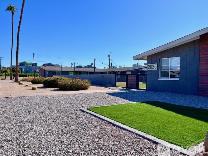 A gravel driveway leads to a house with the number 2625 on it.