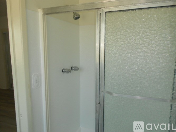 A frosted glass door with a silver handle.
