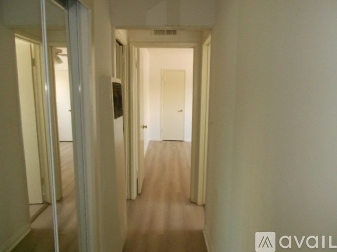 A long hallway with a door at the end.