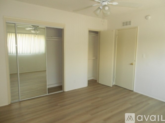 A room with a sliding door and a ceiling fan.