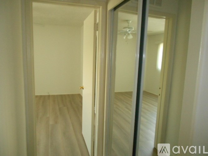 A hallway with a mirror on the wall.