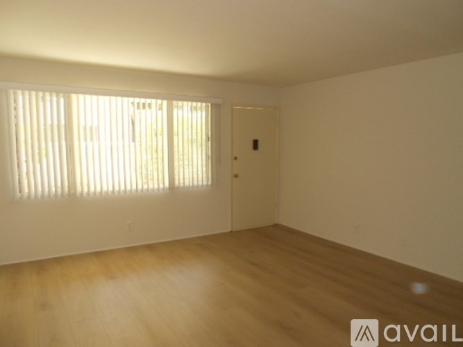 A room with wooden floors and a door.