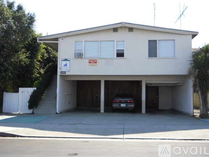 A two-story house with a car parked in the garage.