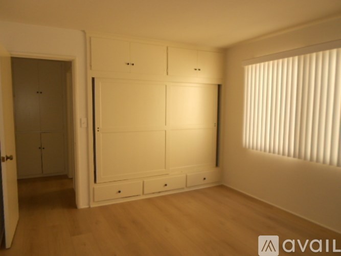 A room with a large cabinet and a door.