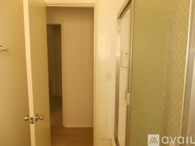 A hallway with a door on the left and a door on the right.