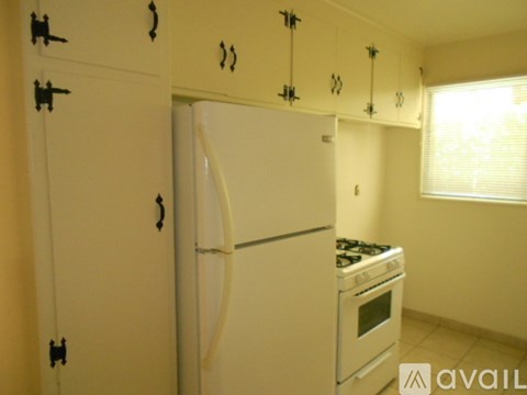 A white refrigerator and oven in a kitchen.