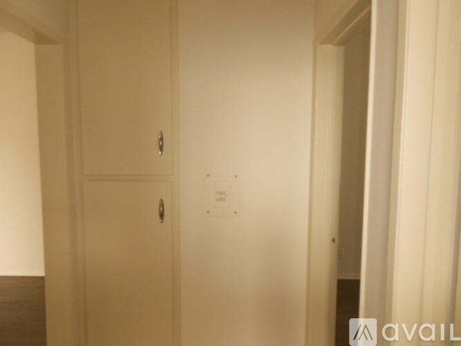 A white door with a handle is in a room.