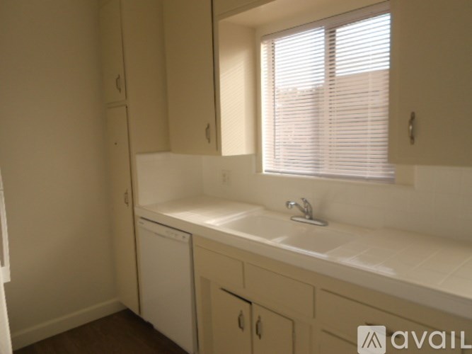 A bathroom with a sink, mirror, and washer and dryer.