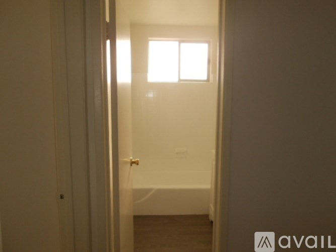 A bathroom with a toilet and a window.