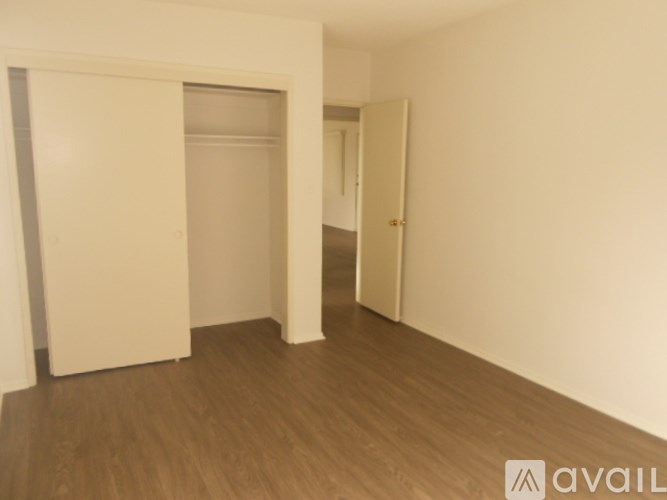 A room with a white door and a white wall.