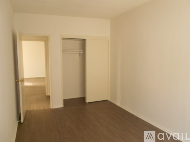 A room with a wooden floor and white walls.