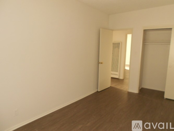 A room with wooden floors and white walls.