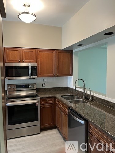 A kitchen with wooden cabinets and stainless steel appliances.