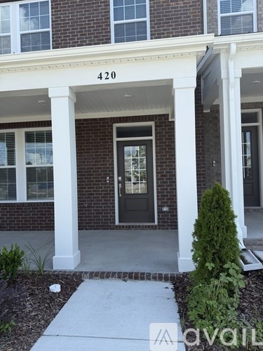A brick building with the number 420 on the front.
