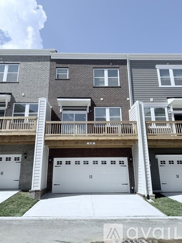 A row of townhouses with garages in front.