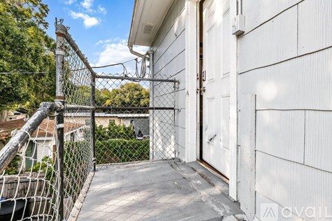 A white house with a metal fence and gate.