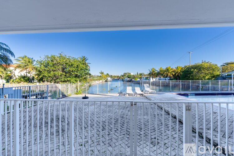 A spacious room with tiled flooring and a sliding glass door.