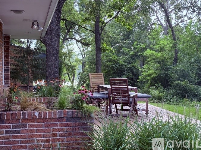 A house with a wooden deck and a flag on the garage door.