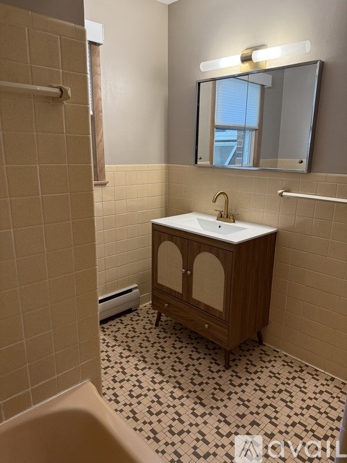 A bathroom with a sink and a mirror.