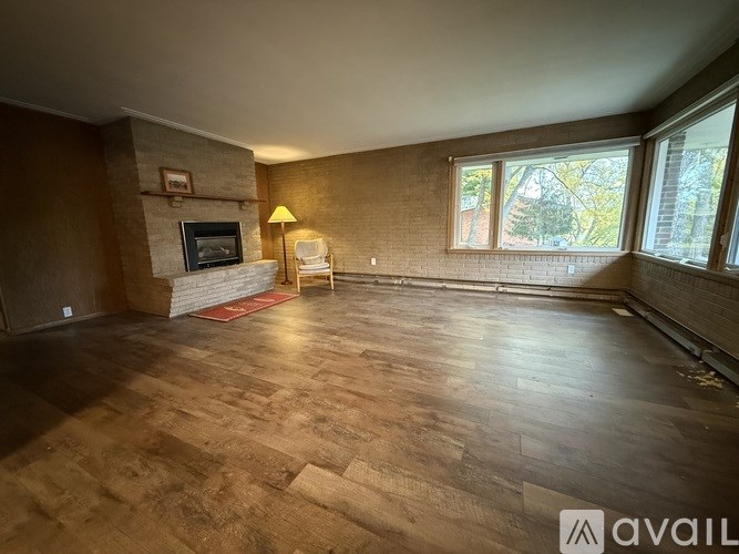 A living room with a fireplace and a chair.