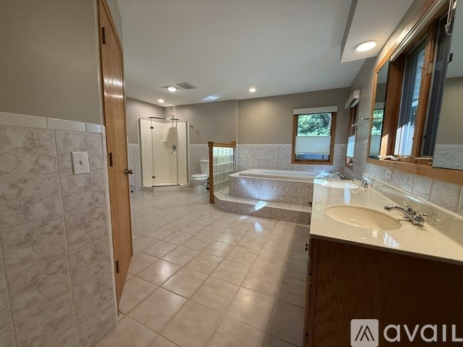 A bathroom with a toilet and a walk-in shower.