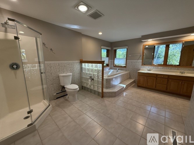 A room with two wooden doors and a carpeted floor.