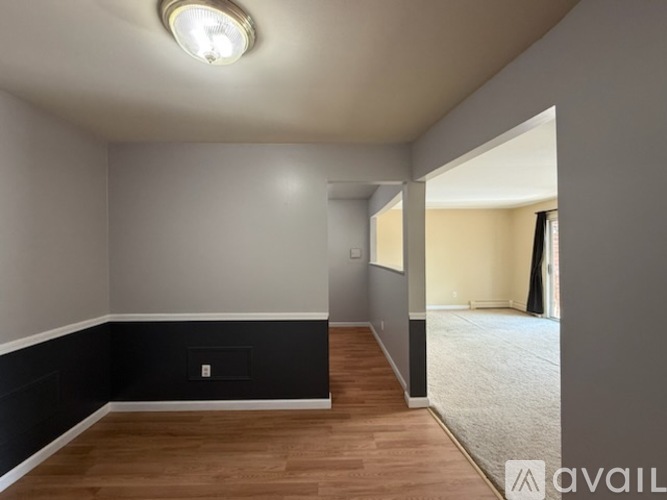 A room with a wooden floor and a light on the ceiling.