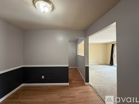 A room with a wooden floor and a light on the ceiling.