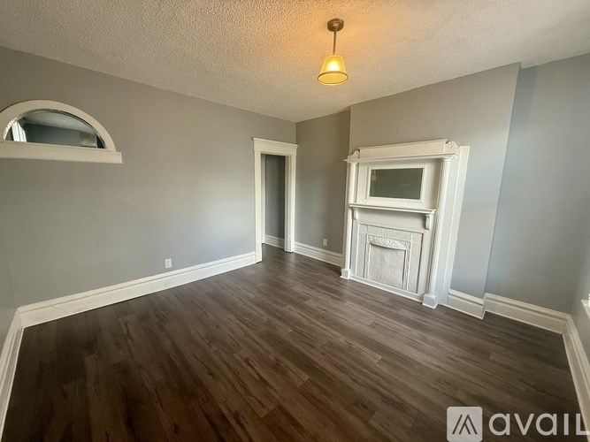 A room with a fireplace and a window.