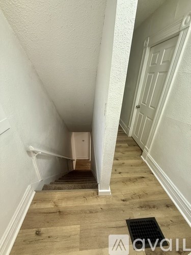 A staircase with a white door at the top.