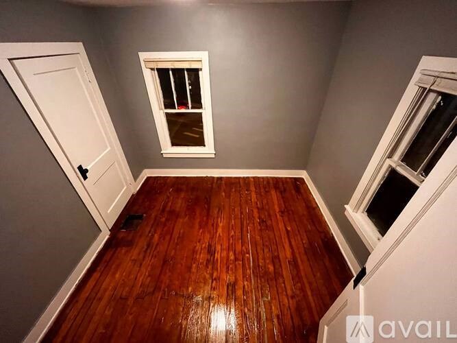 A room with wooden floors and a window.