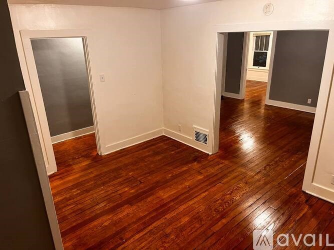 A room with wooden floors and white walls.